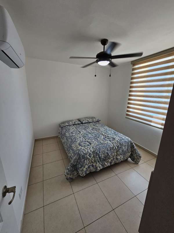 Bedroom with ceiling fan floral bedspread closet PH Royal Pacific Punta Pacifica Panama