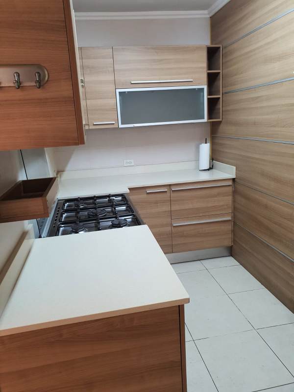 Compact modern kitchen with light wood cabinets PH Royal Pacific Punta Pacifica Panama