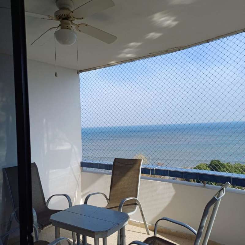 Balcony overlooking skyline and Pacific Ocean with glass sliding doors apartment Grand View Tower Panama City