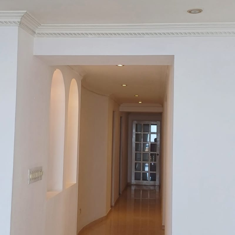 Large curved balcony with glass railings, safety netting, Pacific Ocean and skyline views rental apartment Panama City