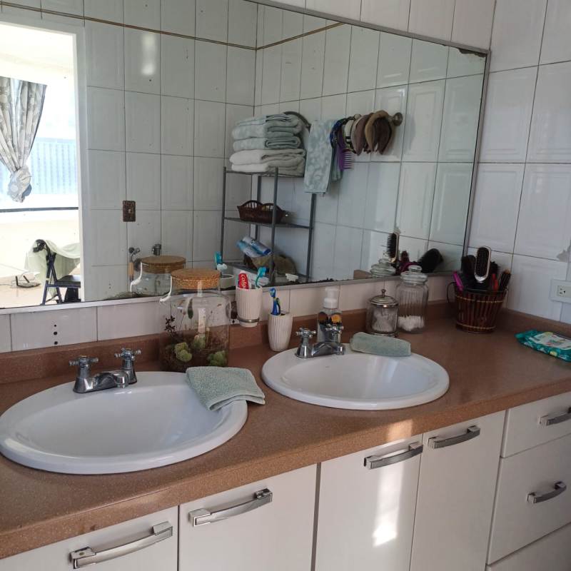 Bathroom with twin sinks, granite top, large mirror in luxury apartment rental Grand View Tower San Francisco Panama