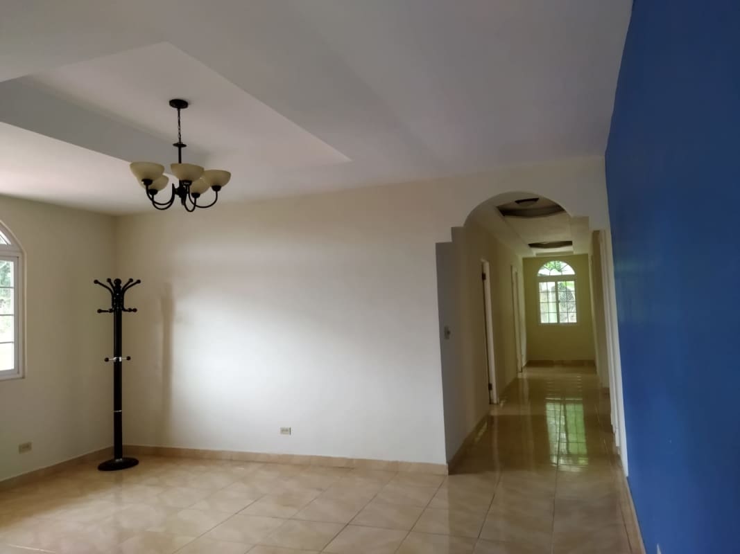 Bright tiled living area with ceiling fan near windows Las Cumbres spacious house for sale Panama