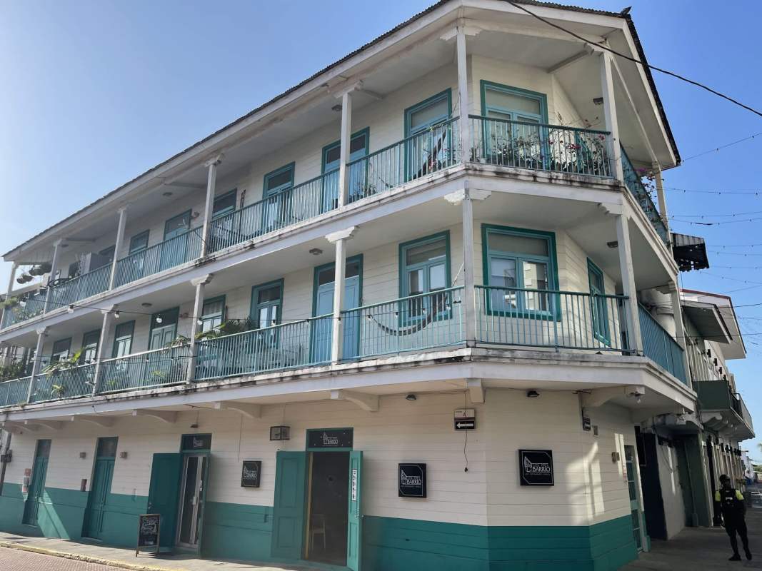 Eclectic cafe bar area with exposed beams, colorful walls, modern lighting Casco Viejo Panama