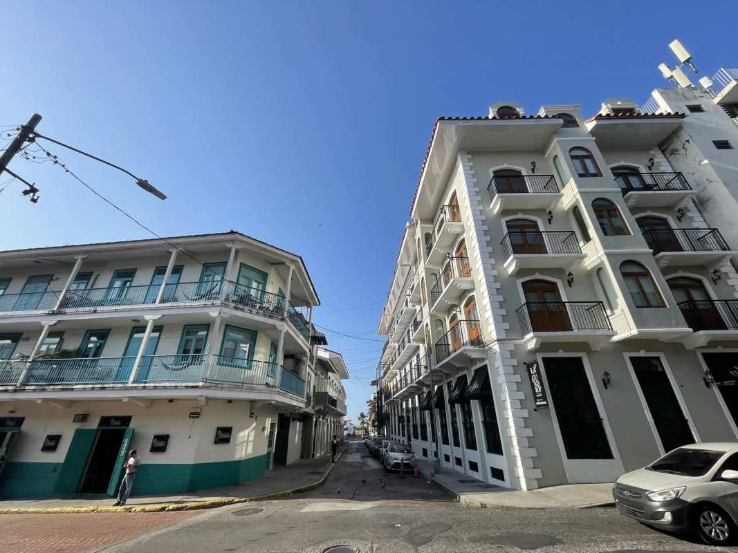 Multi-story colonial corner building with balconies and street view Casco Viejo Panama