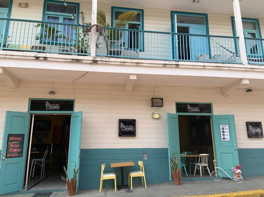 Three-story historic building with wooden balconies corner location Casco Viejo Panama