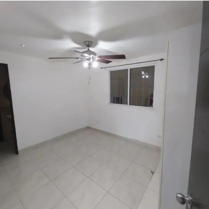 Minimalist bedroom with ceiling fan and window PH Altos de Panamá Condado del Rey Panama