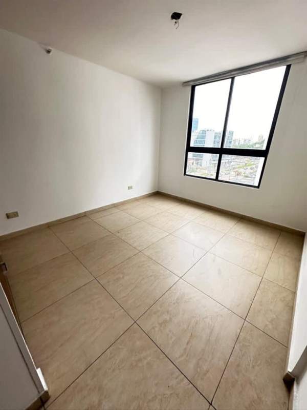 Spacious bedroom with large window, built-in wardrobe, tile floors in PH Terrazas del Rey Panama