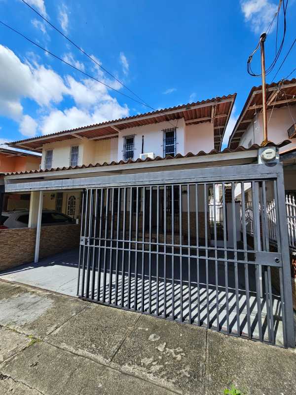 Two-story house with metal gate, covered carport, and balcony in Condado del Rey Panama