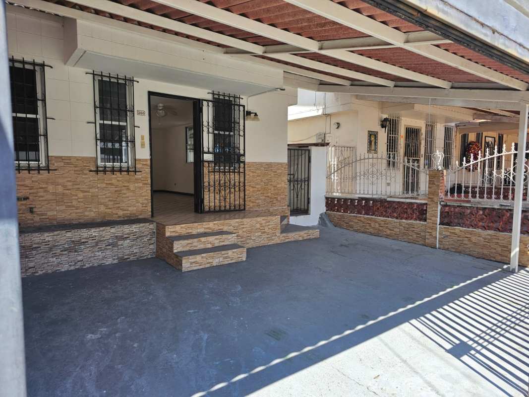 Traditional home facade with parking gate in Condado del Rey Panama City