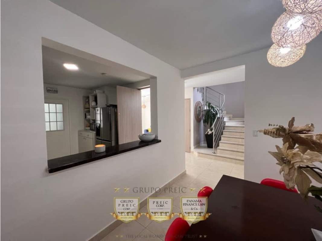 Open plan dining room with pendant lights and window in Reserva de Versalles duplex Panama