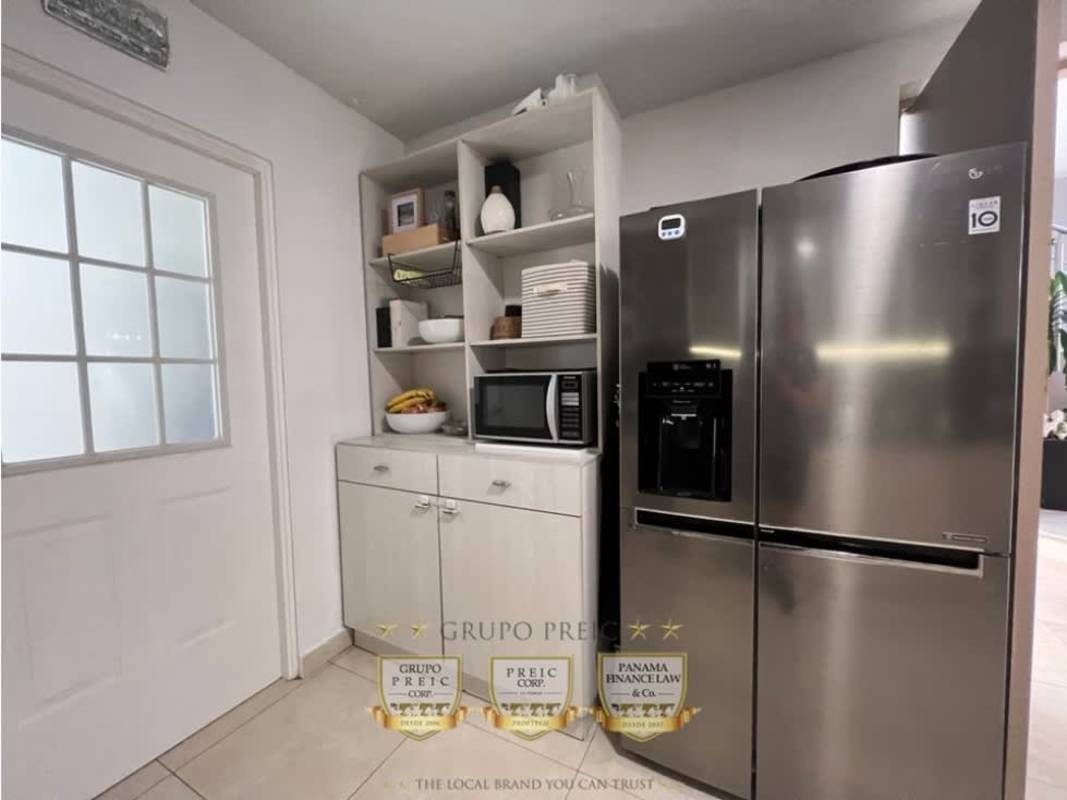 Bedroom with large window, blinds, tiled floors in Reserva de Versalles duplex Panama City