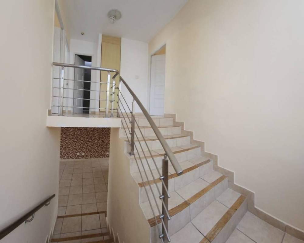 Contemporary duplex house facade blue and white with carport PH Alpes Brisas del Golf Panama