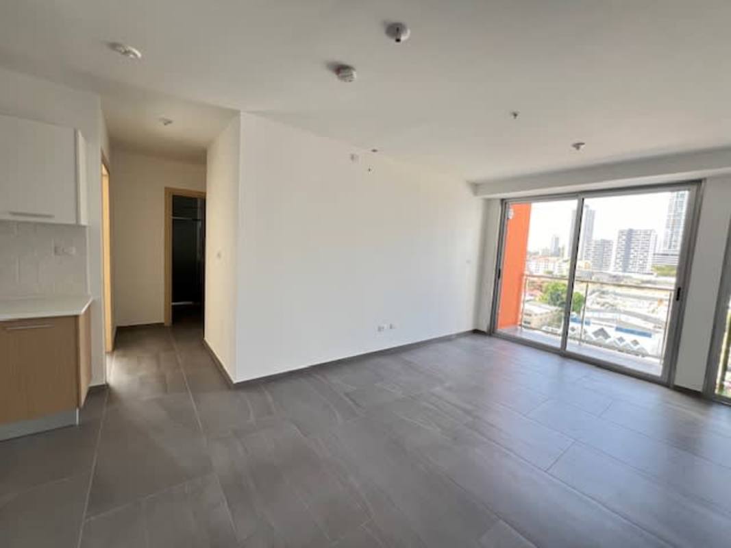 Outdoor pool deck with lounge chairs, pergolas and skyline views PH Midtown Panama