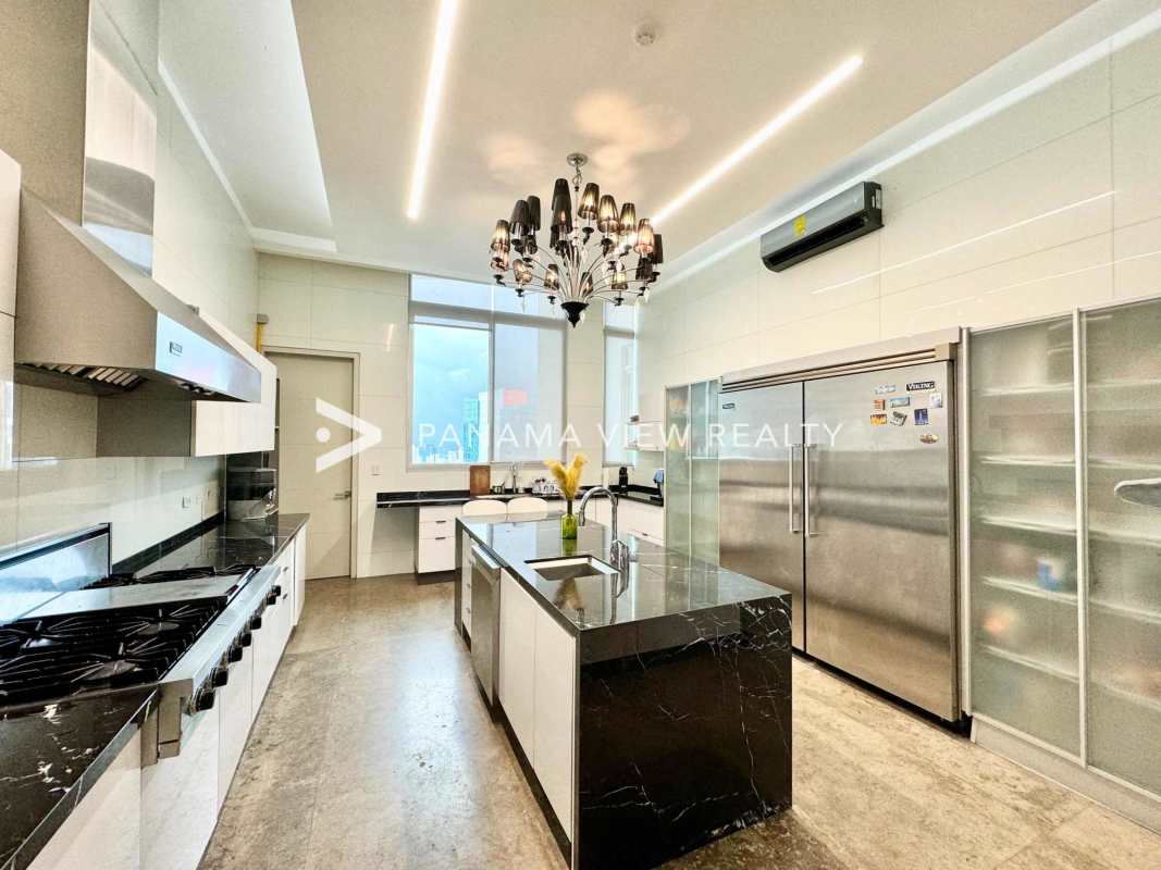 Luxury kitchen with marble counters, island, gas stove, stainless steel appliances in PH Blue Bahia Punta Pacifica