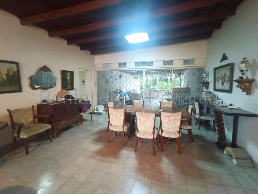 Traditional large open living and dining space with tile floors and natural light in San Francisco Panama house