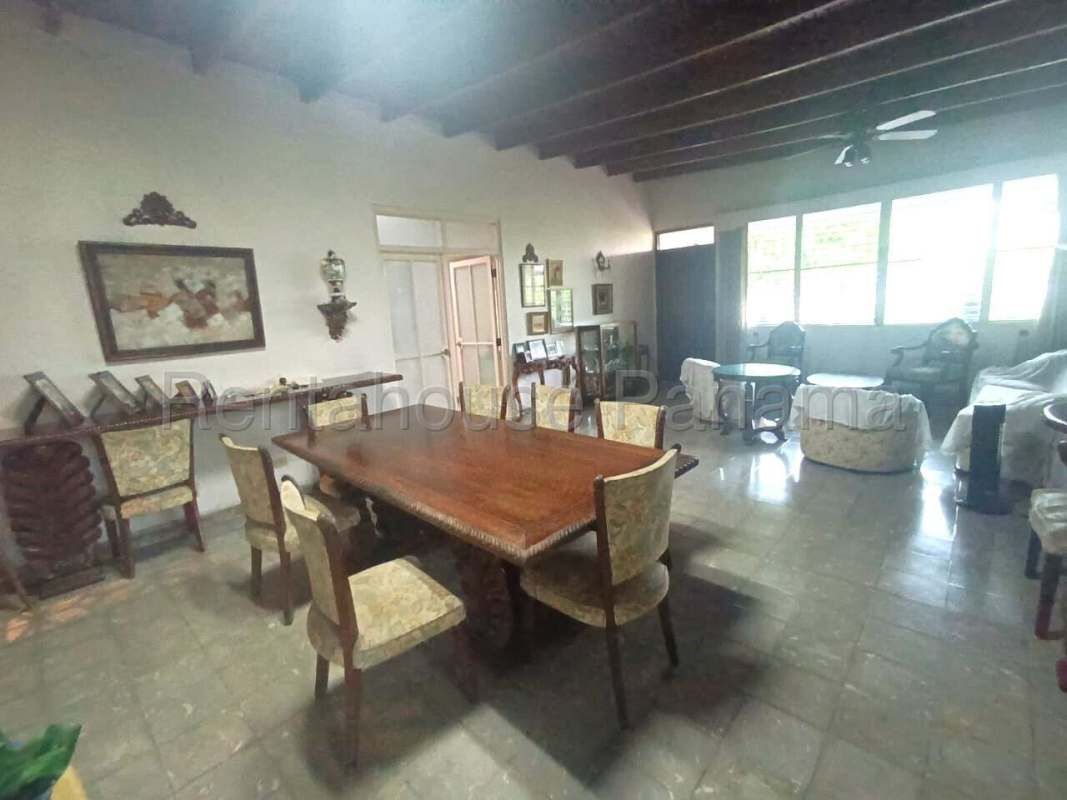 Large dining area with exposed wooden beams, ceramic floors, natural light in Panama City house for sale