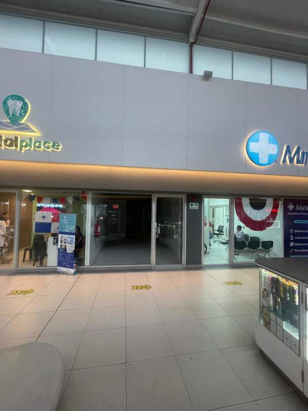 Shopping mall corridor with glass commercial spaces at San Isidro Plaza Metro Panama