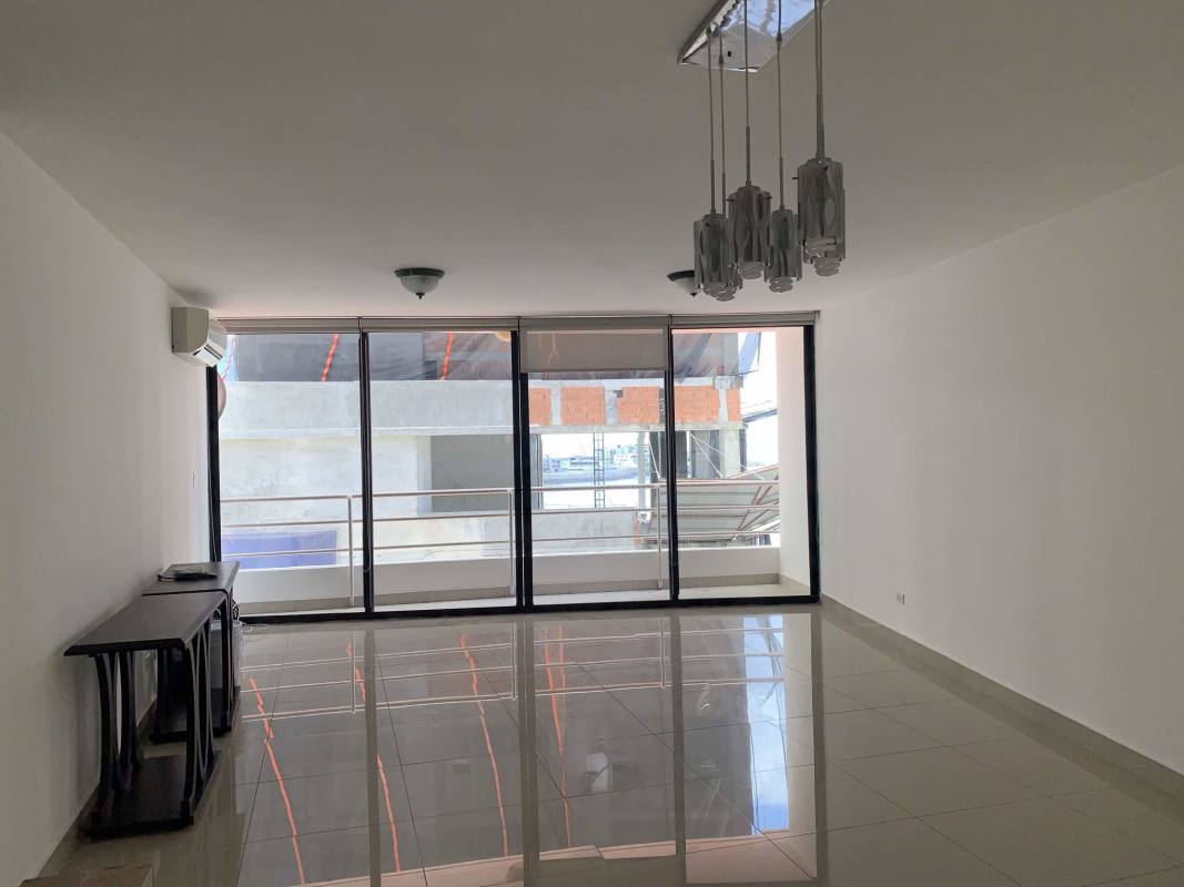 Modern living room with sliding doors to balcony and tiled floor in PH Royal Princess