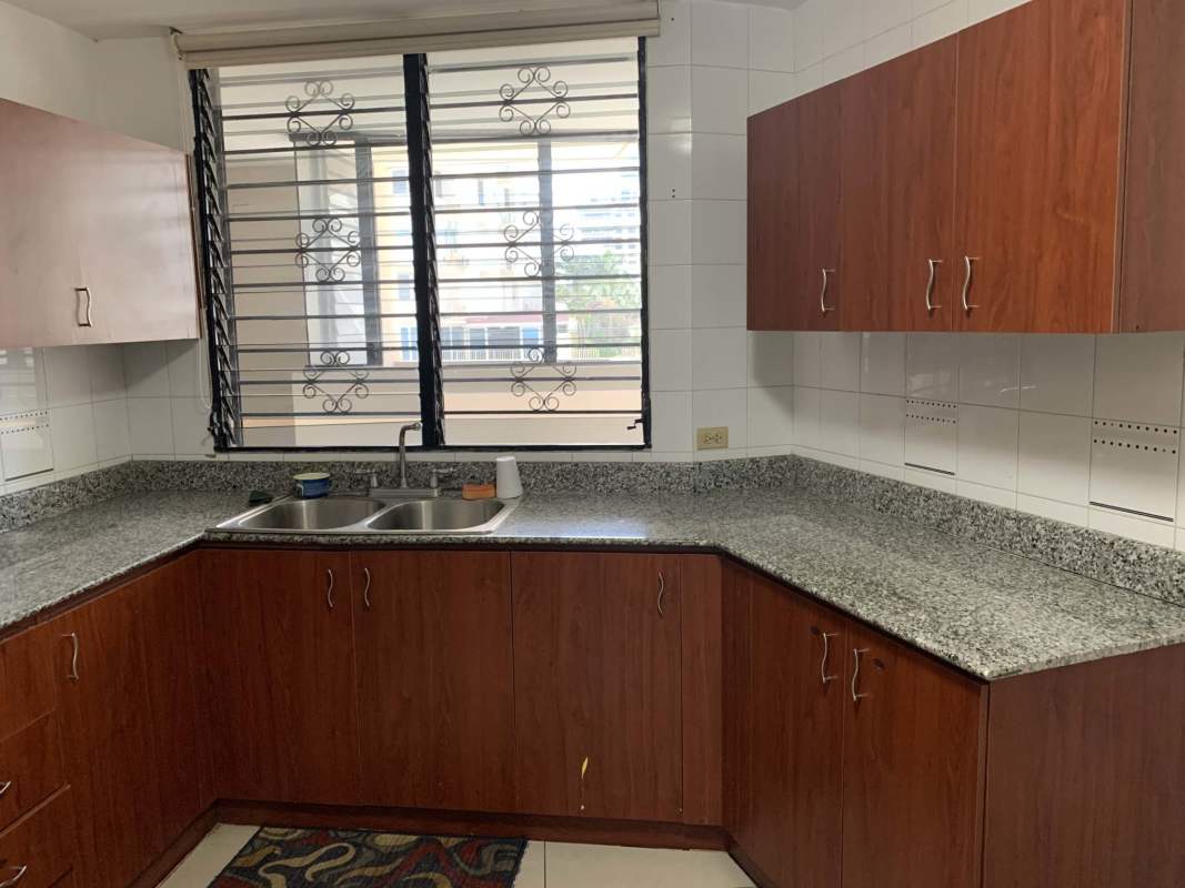 Kitchen with wooden cabinets granite counters large window in PH Royal Princess Punta Paitilla