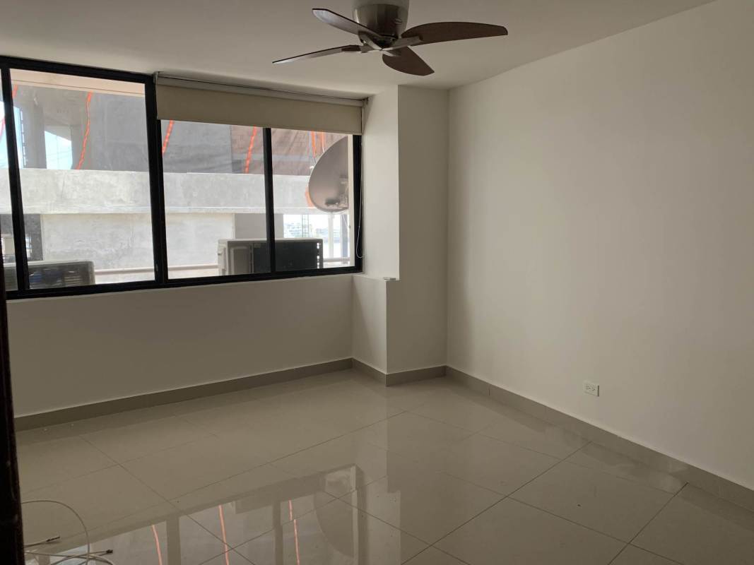 Bright bedroom with tiled floor, ceiling fan, large window in PH Royal Princess