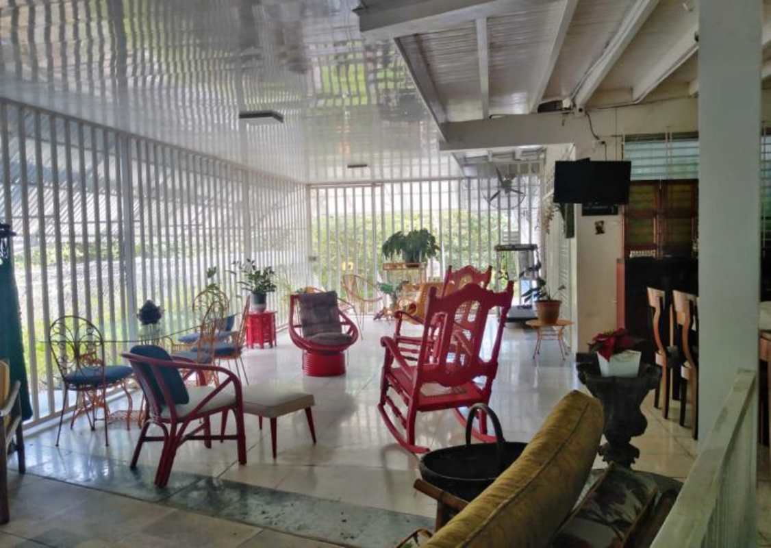 Classic kitchen with white cabinetry granite counters gas stove in seafront Coco del Mar Panama house