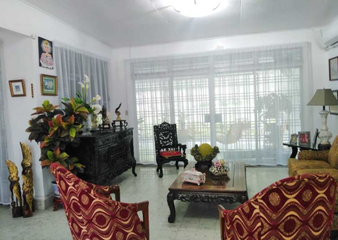 Traditional living room with ornate furniture garden view in oceanfront house Panama