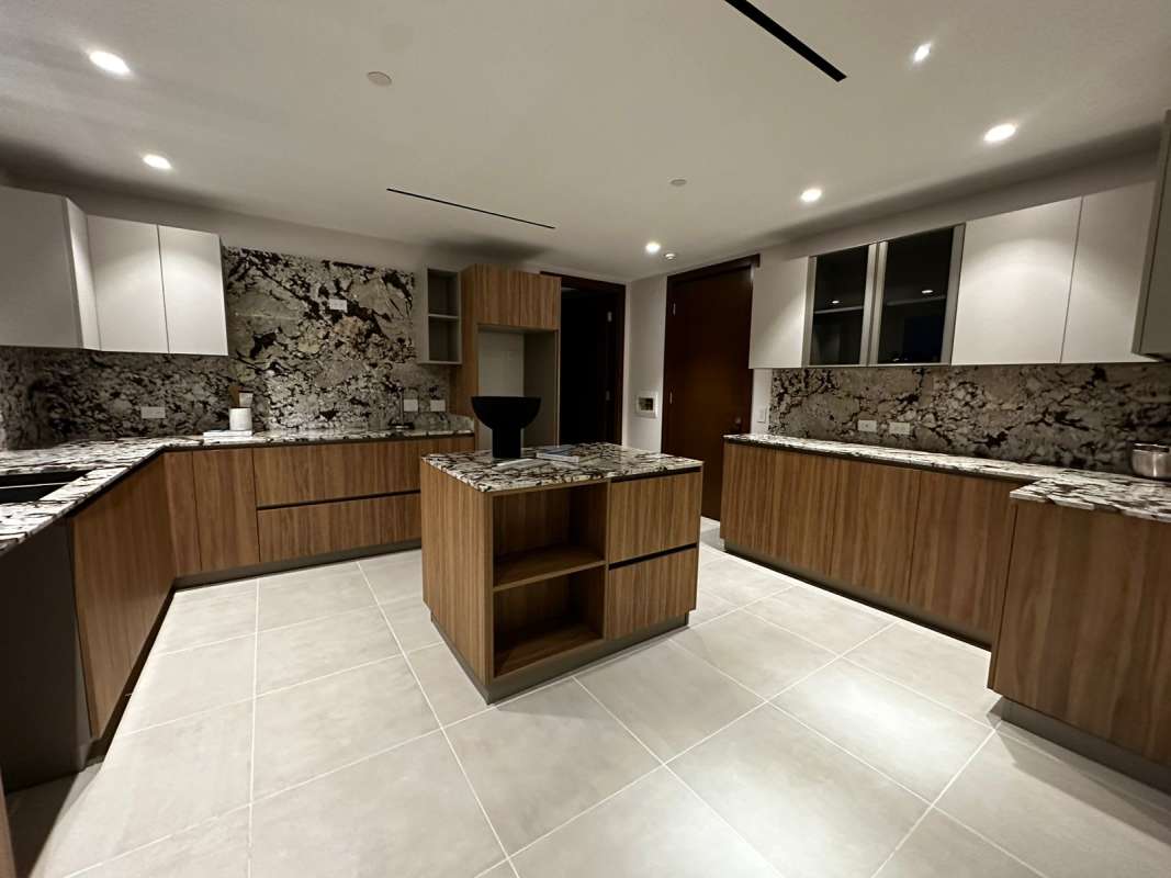 Modern marble bathroom with glass-enclosed shower luxury condo Santa Maria Panama