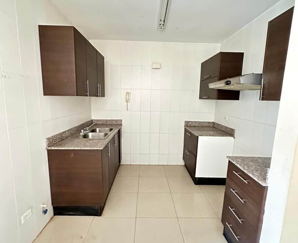 Modern minimalist kitchen with granite counters and brown cabinets in PH Sun City Panama