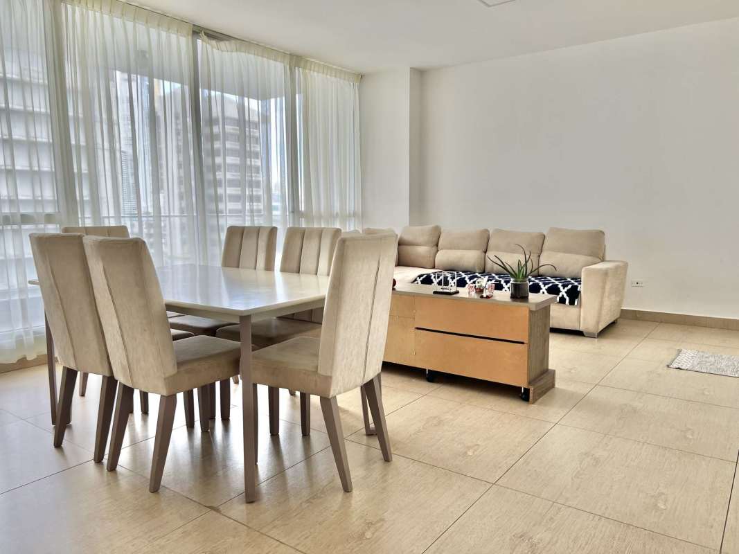 Bedroom with bright window overlooking ocean and city in PH Vista Balboa Panama