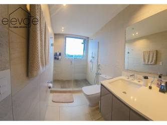 Living room with TV wall, built-in shelving, mirrored accent PH Explora Panama Pacifico