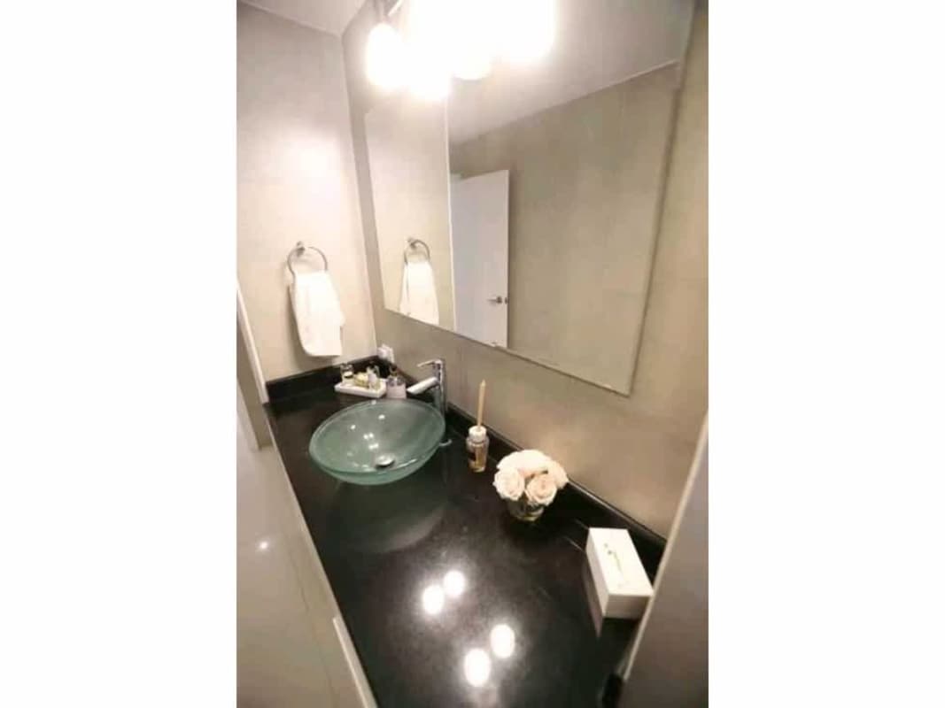 Contemporary bathroom with vessel sink, mirror, and glass accents in PH Tamanaco Panama