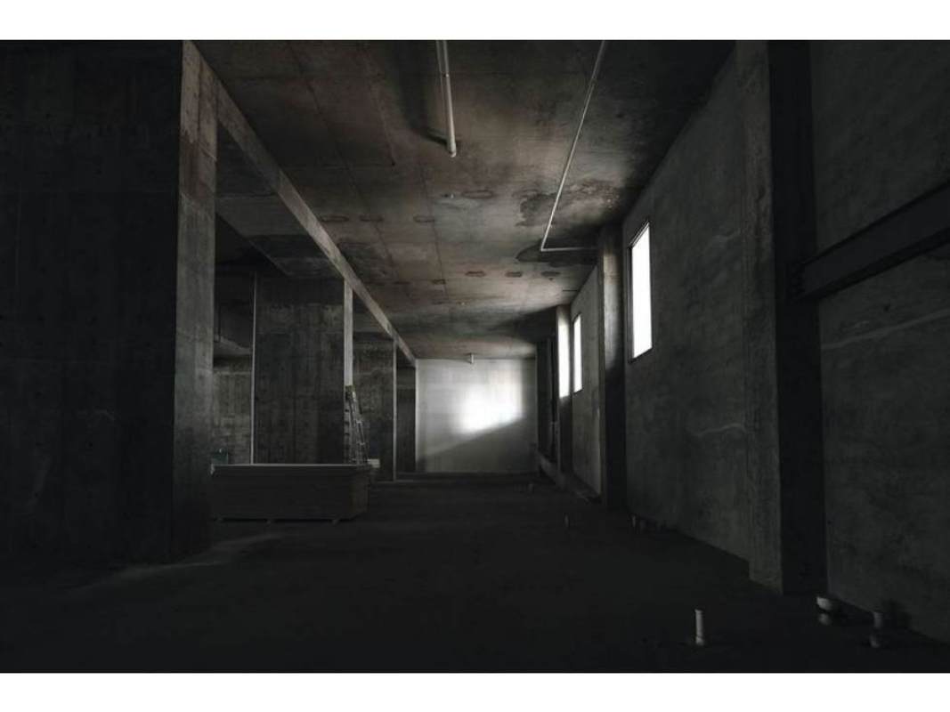 Large open gray commercial space inside Nuovo by Armani Casa with high ceilings