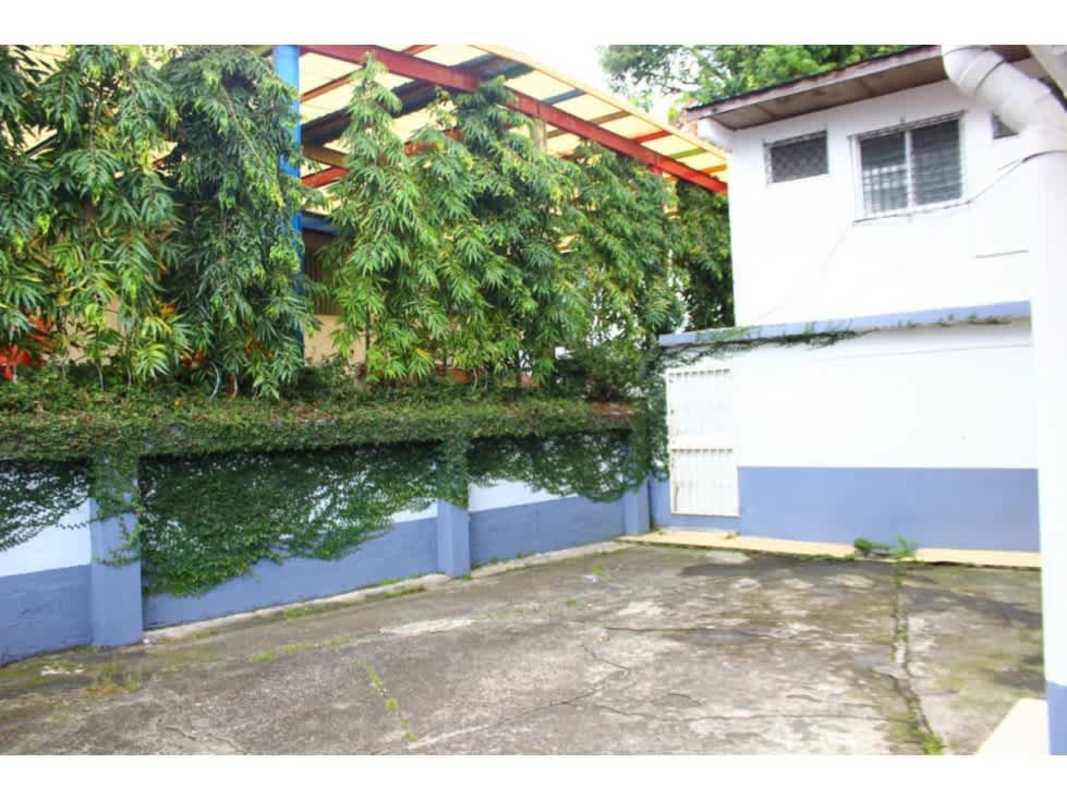 Enclosed cement courtyard with greenery inside mixed-use building San Francisco Panama