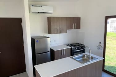 Kitchen with wood cabinetry, gas stove, stainless appliances at Costa Blanca Villas Playa Blanca Anton Panama