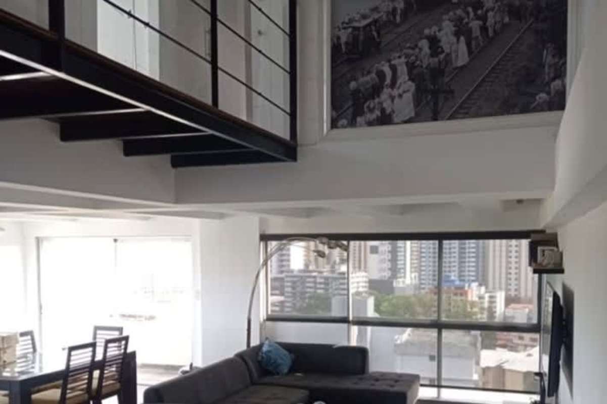 Simple living area with beige sofa, natural light, gray curtains PH Terrazas La Cresta Panama