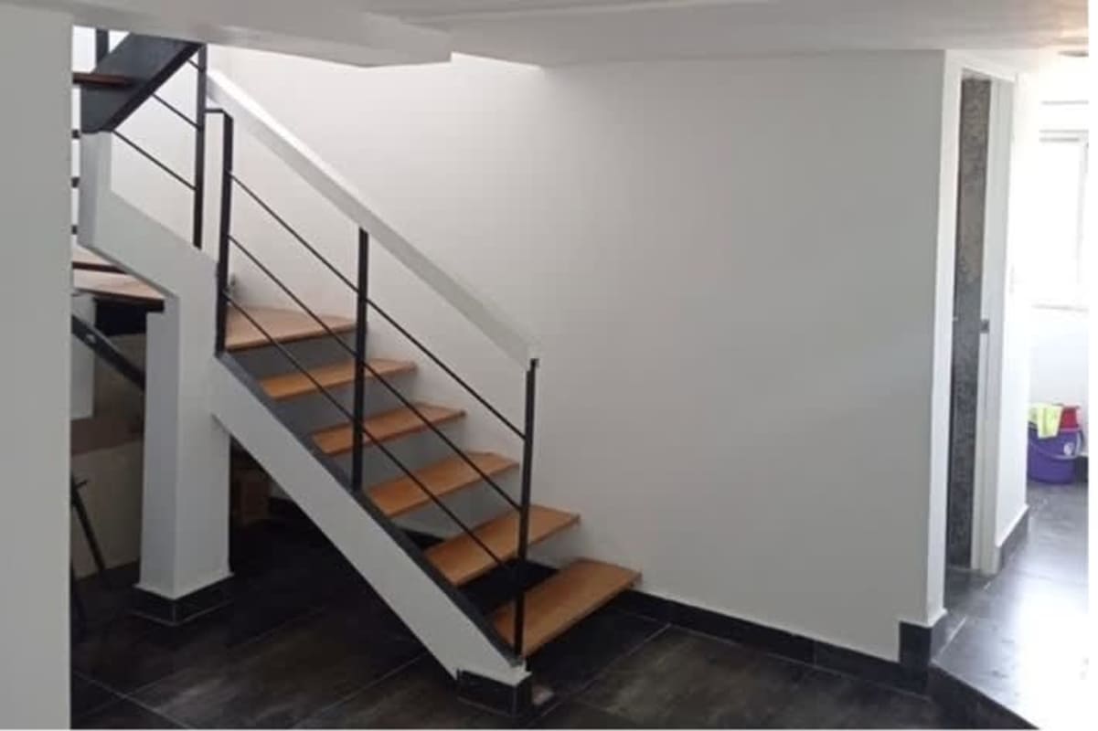Modern floating stairs with wooden steps, minimalist handrail in penthouse loft Panama