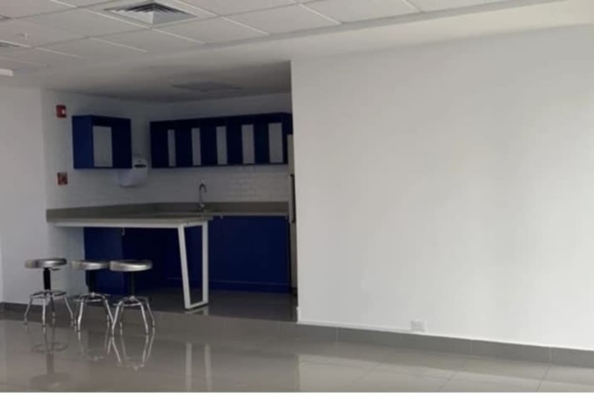 Minimalist kitchenette with blue cabinets and breakfast bar PH BICSA Office Tower Punta Pacifica Panama