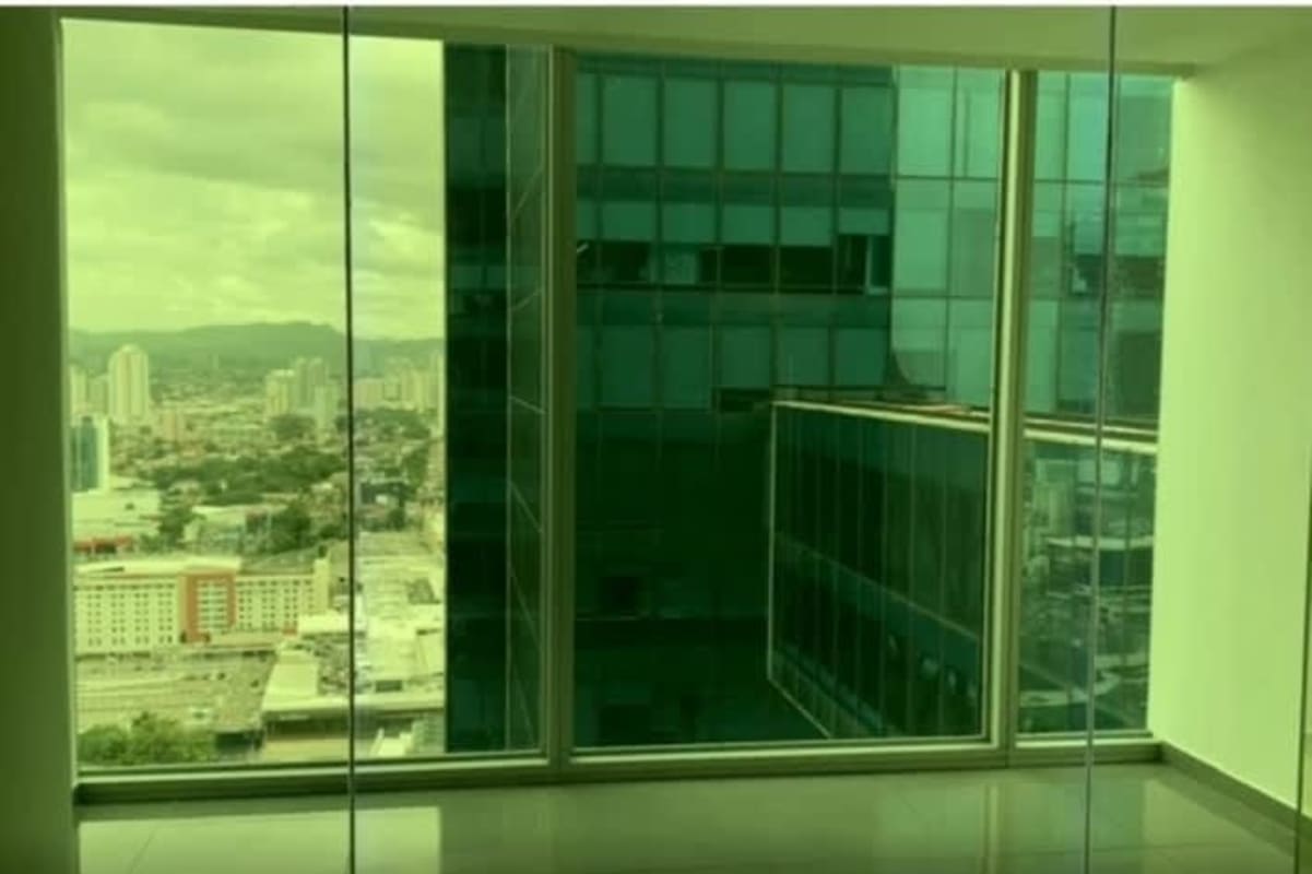 Panoramic skyline view through floor-to-ceiling windows in PH BICSA Punta Pacífica Panama