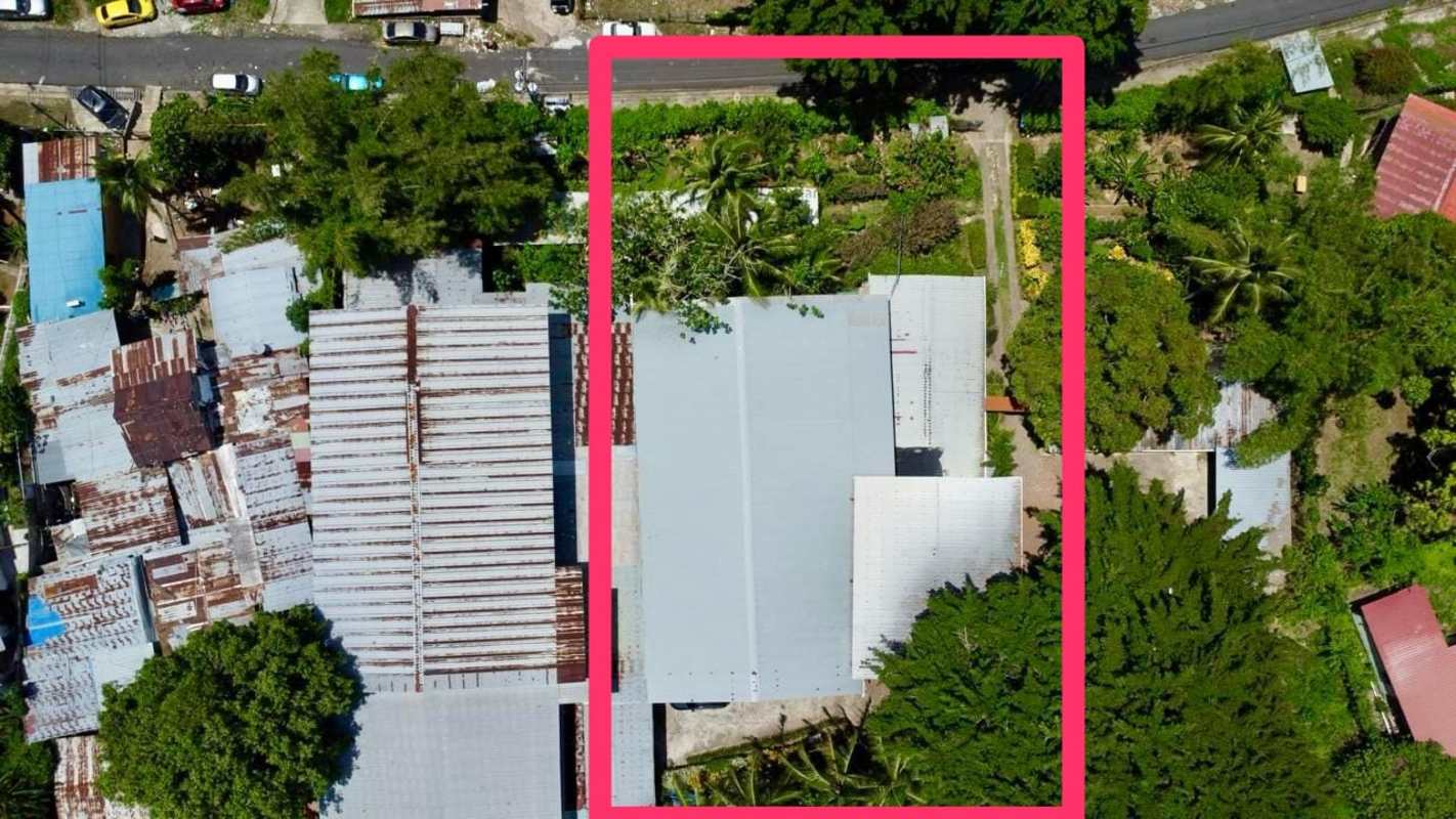 Aerial shot of industrial warehouse complex outlined with metal roof and trees Panama City