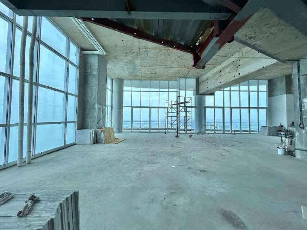 Unfinished penthouse open living space with panoramic windows and skyline views in PH The Point Panama