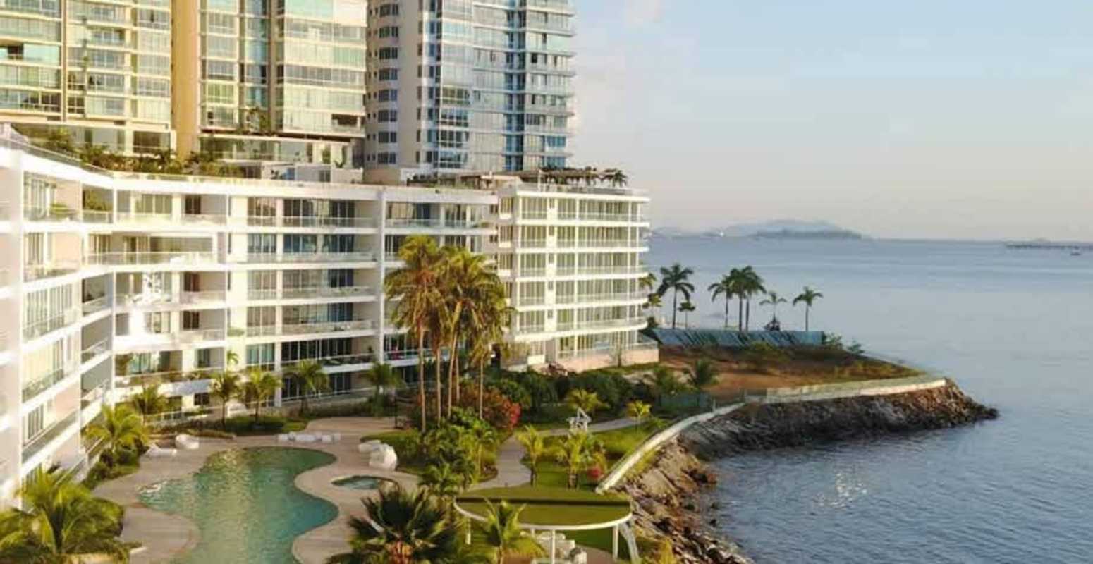 Elegant marble bathroom with double sink vanity, large mirror, bathtub and glass-enclosed shower