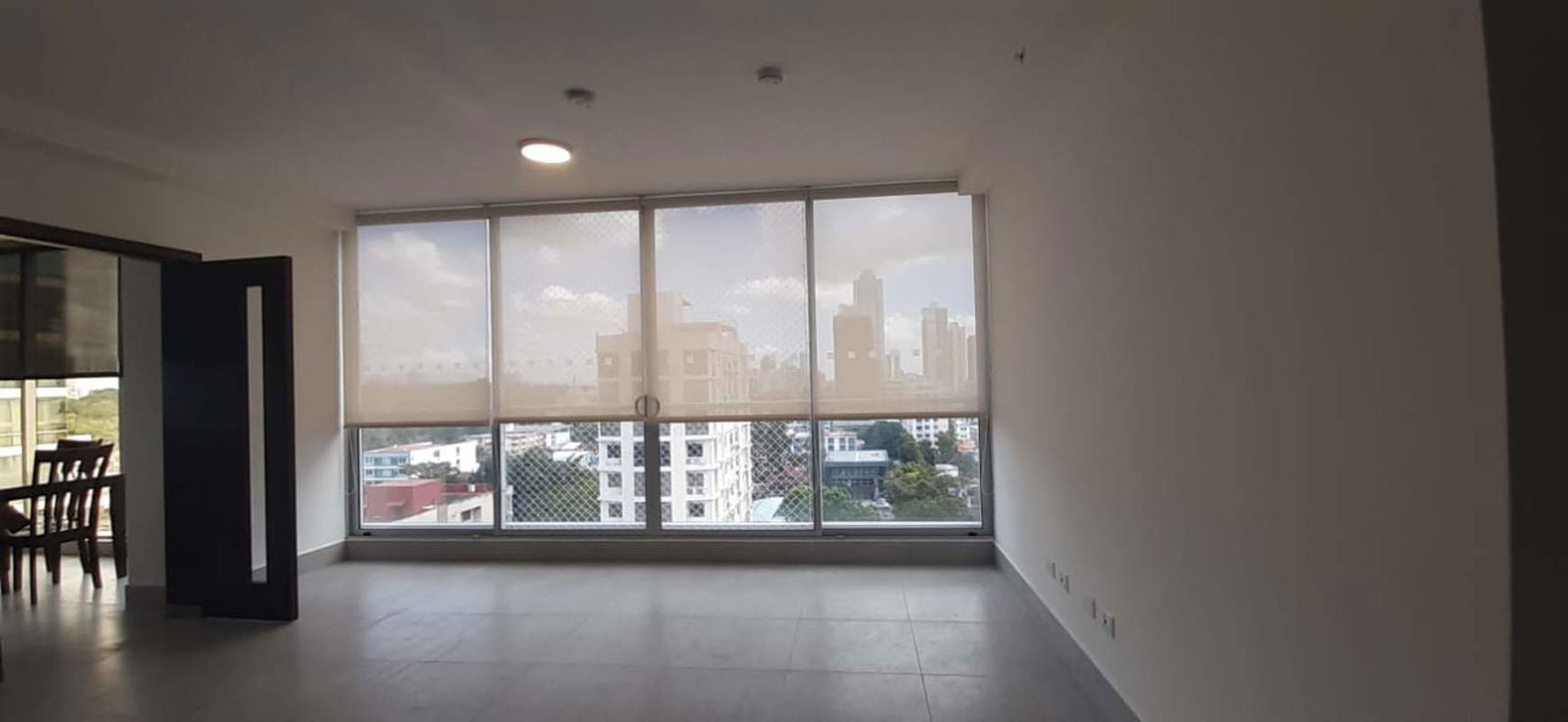 Large panoramic window with urban view inside office space The Office One Tower Obarrio