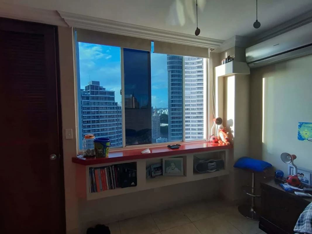 Bedroom with large window skyline view, built-in shelf desk in PH El Cangrejo Palace Panama
