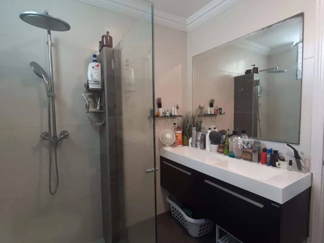 Dining room with glass doors to balcony, chandelier, stairs in penthouse PH El Cangrejo Panama