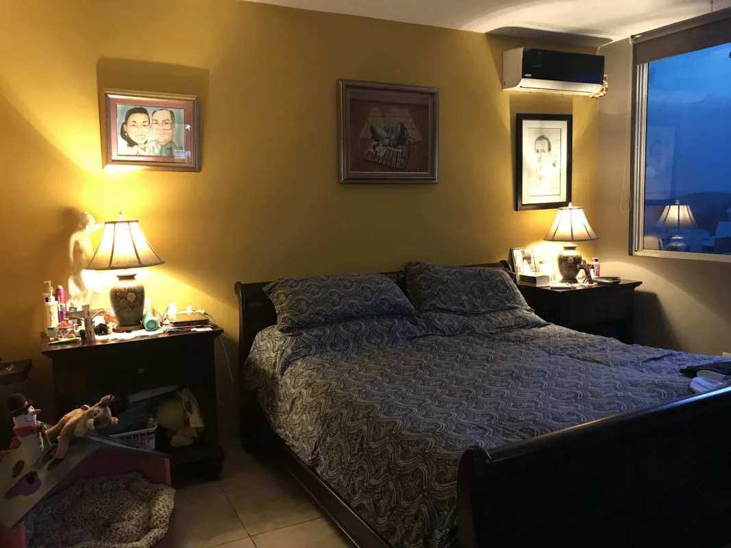 Master bedroom with large window city view, split AC, yellow accent wall in PH El Cangrejo Palace