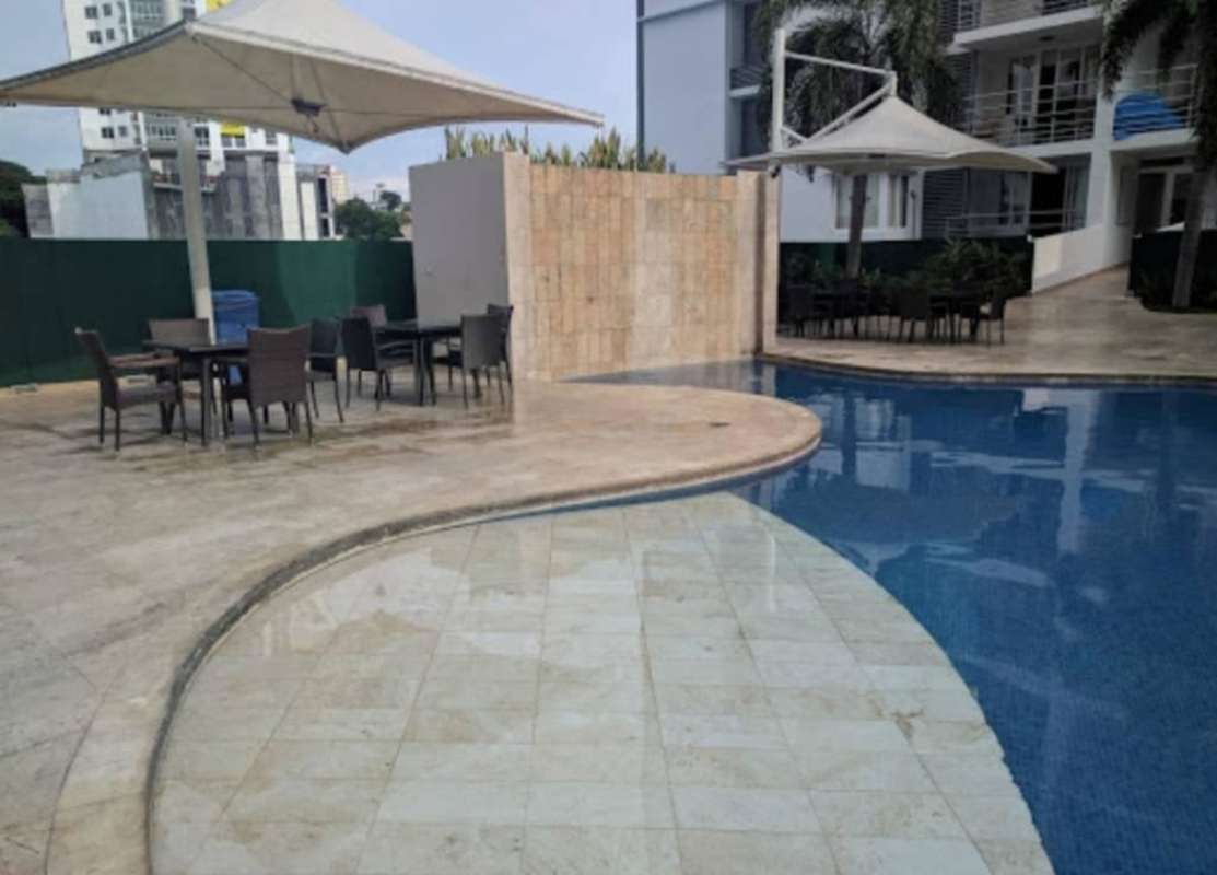 Curved swimming pool lounge chairs umbrellas Cosmopolitan Tower Panama