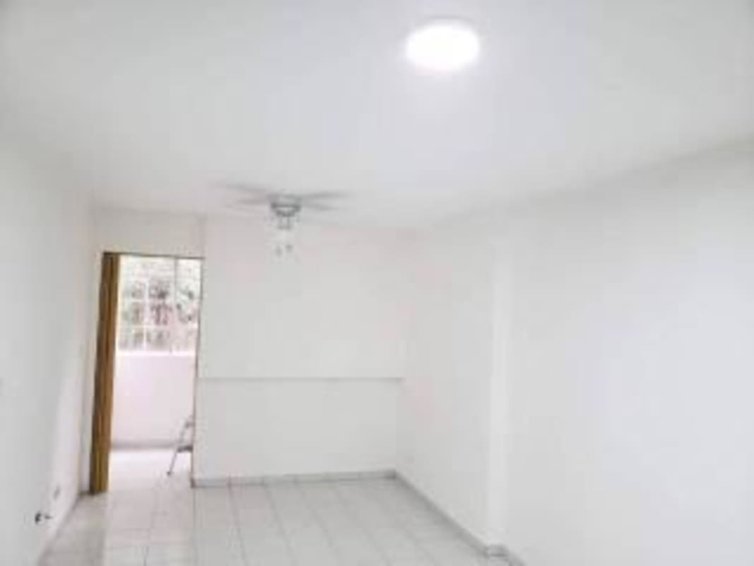 Living room with tiled floors, natural light, ceiling fan in Bella Vista apartment for sale Panama