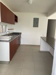 Equipped kitchen with wood cabinets, granite counters, built-in stove at Villas de Arraiján Arraiján Panama