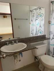 Bathroom with walk-in shower, granite counter sink, mirror at Villas de Arraiján