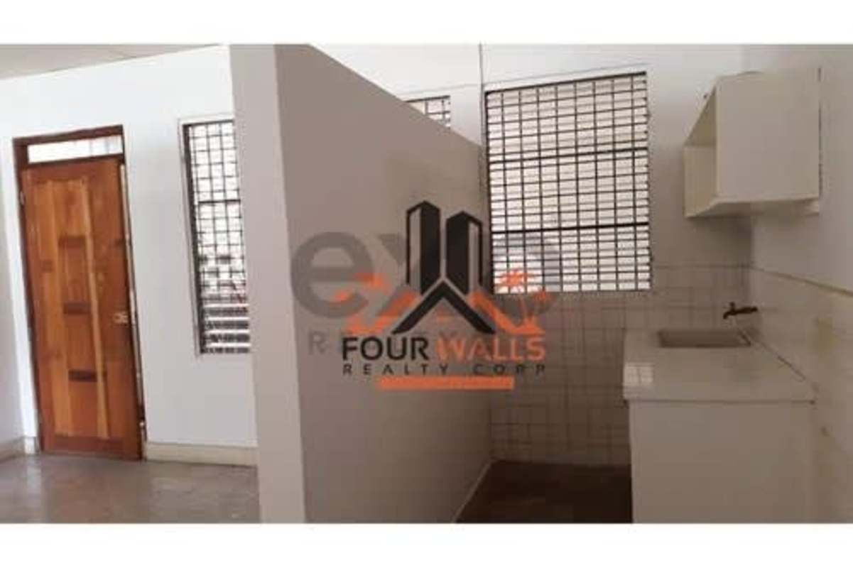 Small kitchenette with marble backsplash, adjacent bathroom PH Obarrio Tower